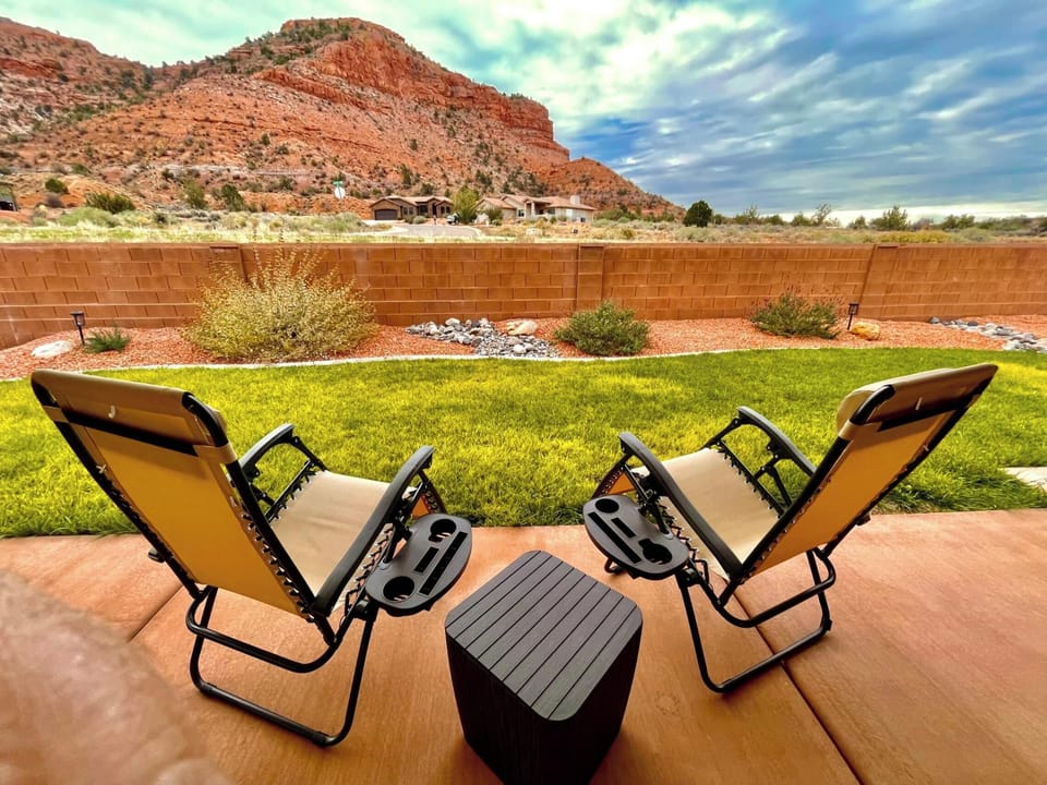 Unwind in zero-gravity loungers with stunning red rock views at Maison Sans Souci, Kanab's ultimate backyard retreat.
