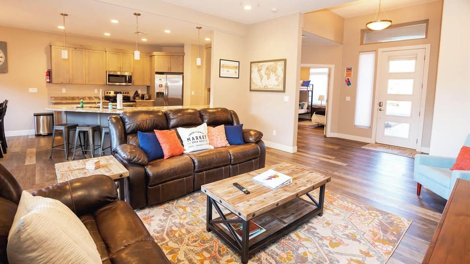 Spacious open-plan living area flows into a fully equipped kitchen at Maison Sans Souci, Kanab's pet-friendly getaway.