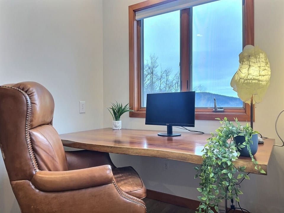 Dedicated office space with a comfy leather chair.