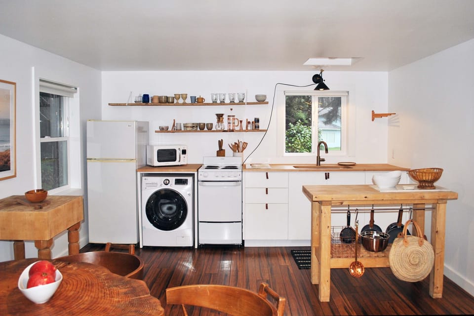 Two islands add to the prep space in this kitchen as well as a washer/dryer combo.