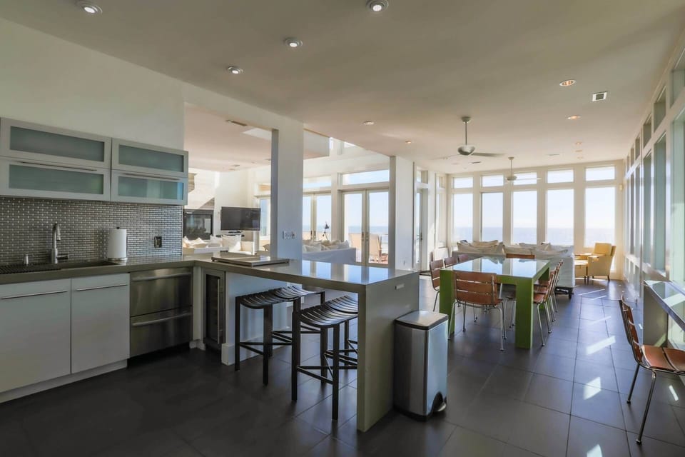 The open floor plan in the kitchen, living room & dining areas provides mesmerizing views of the sea.