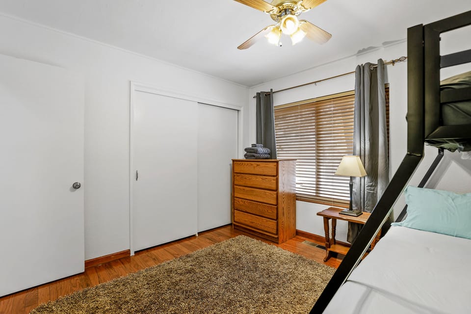 Bunk room with spacious closet and blackout curtains