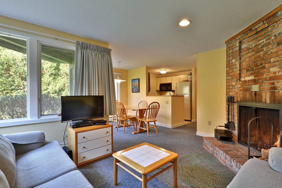 Open floor plan view from the cozy living room into the dining and kitchen area