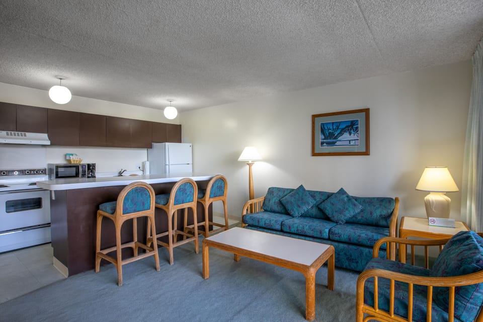 Settle into your inviting open-concept living space, where a fully equipped kitchen flows seamlessly into the cozy lounge, perfect for unwinding after a day of adventures.