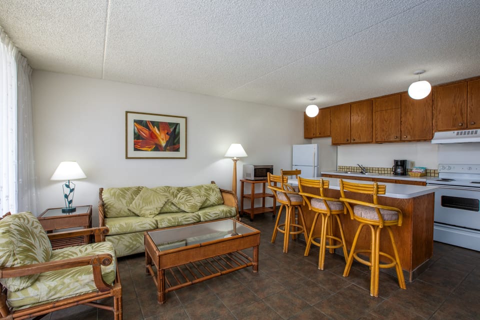 Your open-plan living space combines comfort and convenience, with a cozy seating area flowing into a fully equipped kitchen and breakfast bar—perfect for unwinding or preparing meals together.