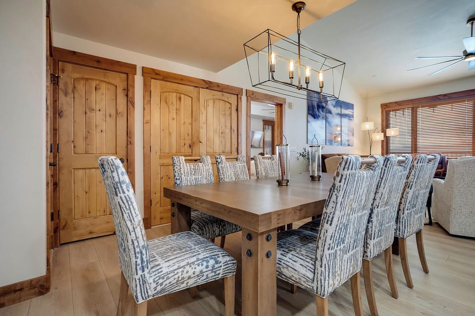 Gather around your elegant dining table where rustic wood meets modern comfort, creating the perfect space for memorable meals together.