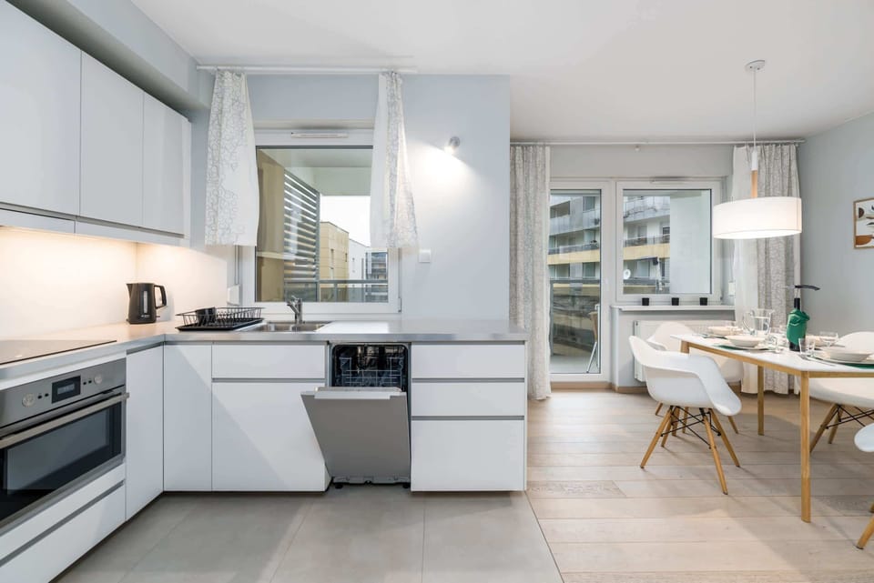 The sleek design of the kitchenette blending seamlessly with the living area.