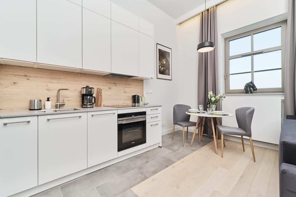 The sleek design of the kitchenette blending seamlessly with the living area.