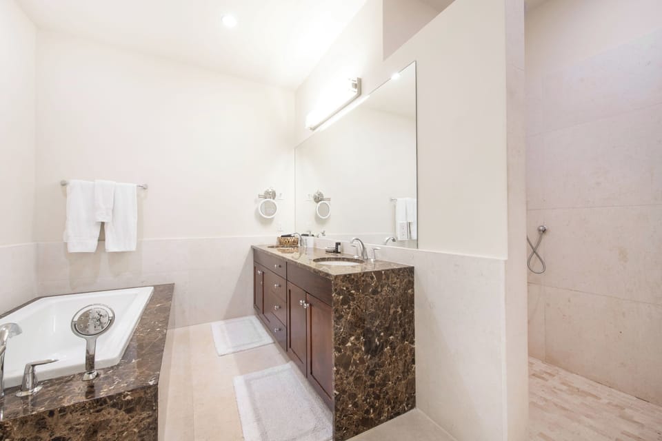 Guest Ensuite #2 with dual vanity, soaking tub, and separate shower.
