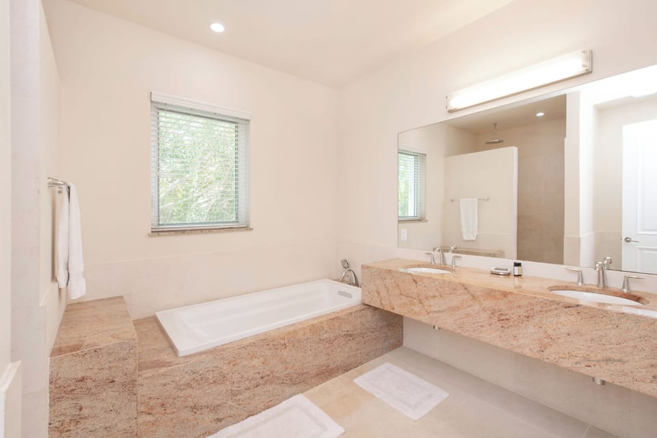 Guest Ensuite #3 with dual vanity, soaking tub, and separate shower.