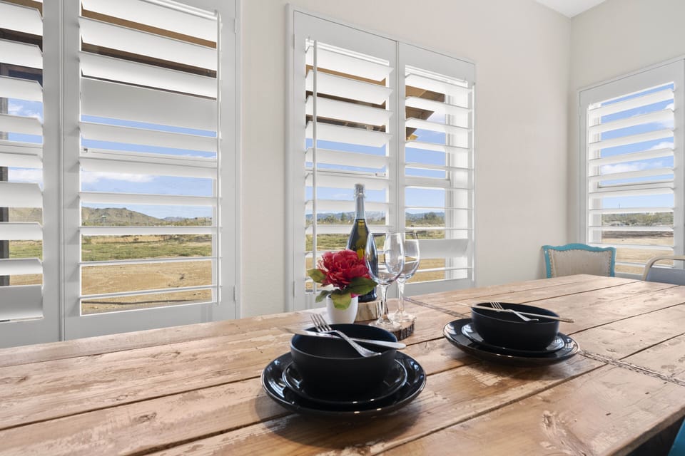 Bright dining space with rustic table and scenic view