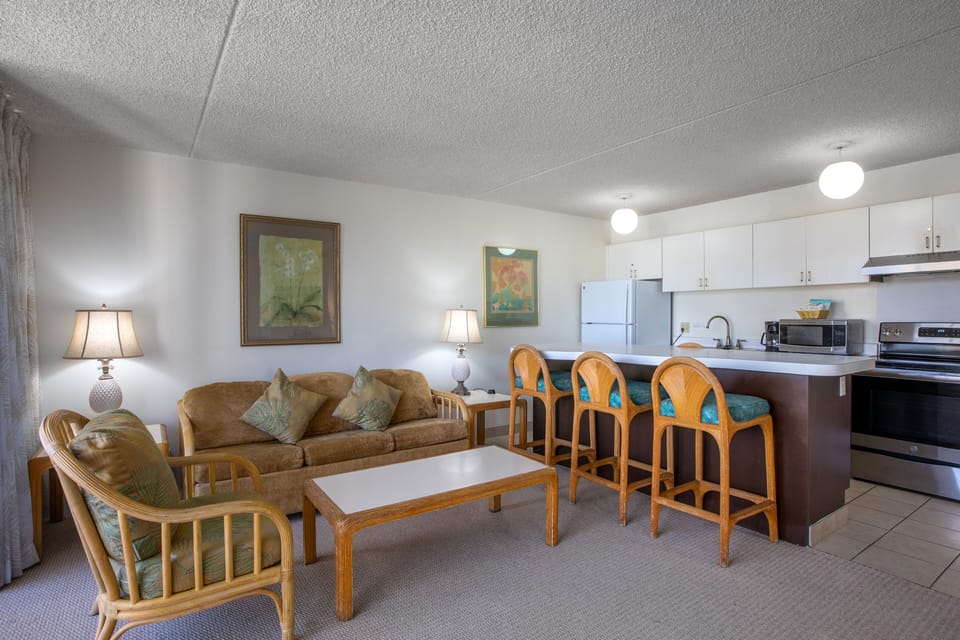 A bright, open layout flows from living area to kitchen, with comfy seating and breakfast bar perfect for your morning coffee or evening gathering.