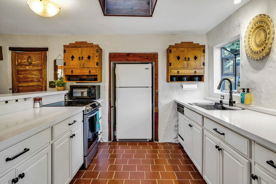 Vintage tile floors, fully equipped kitchen with garden windows and skylight.