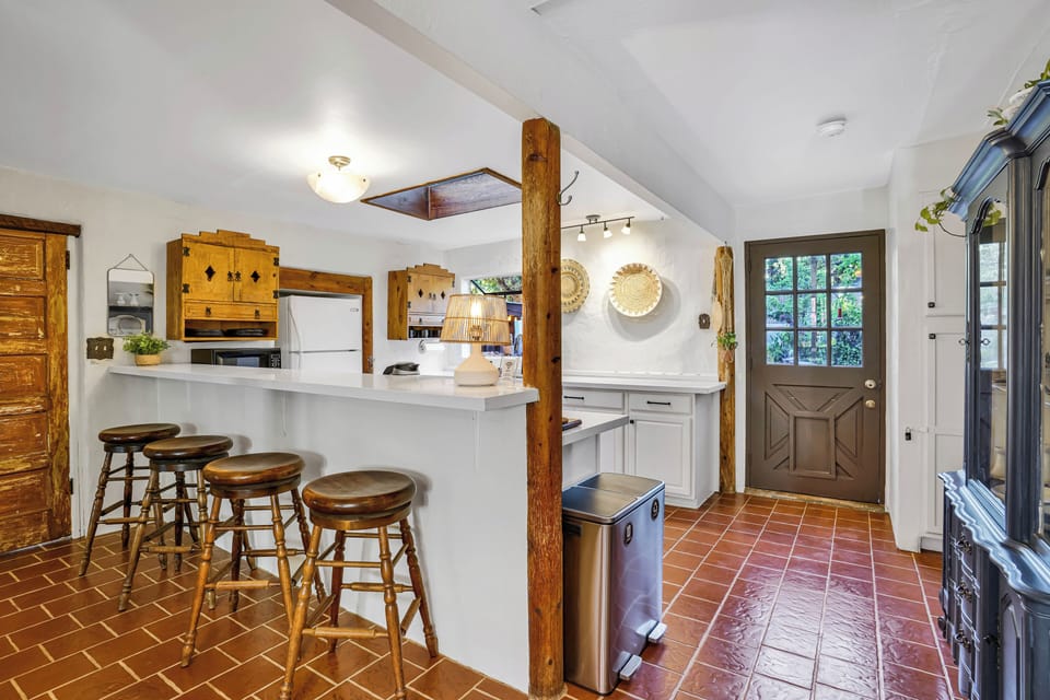 Bar seating, large counters for cooking, hand-crafted cabinetry, local pottery.