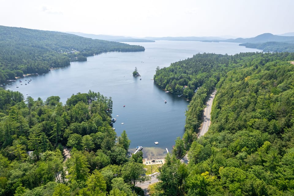 View of lake with cottage on bottom left