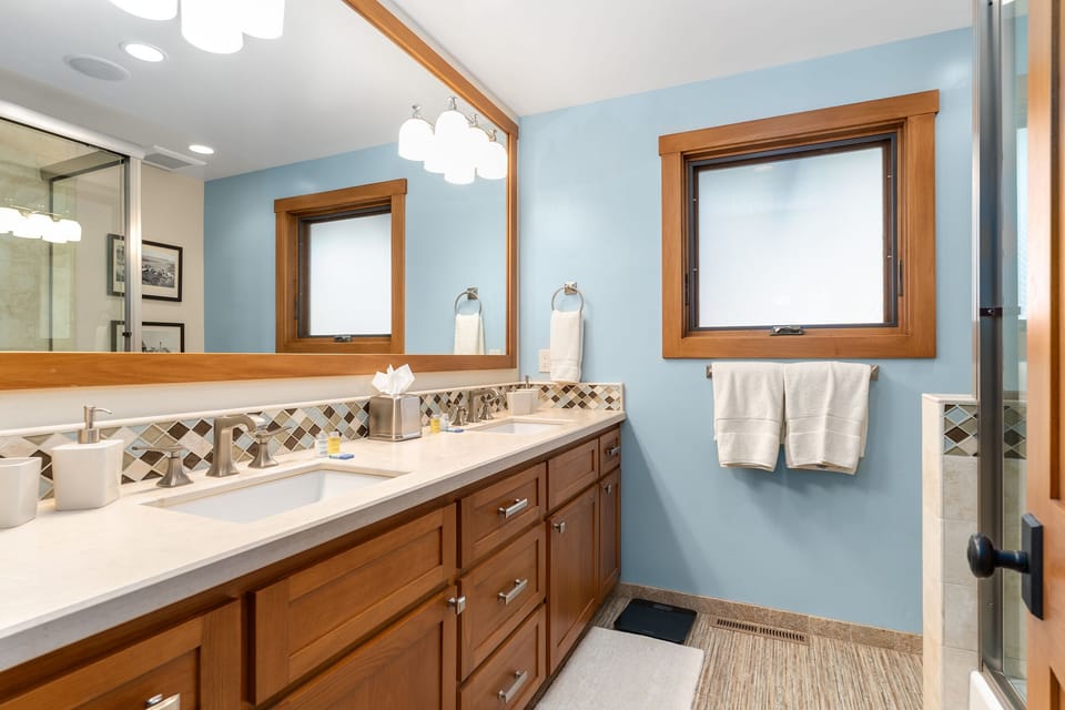 Shared bath with double vanity sinks and bathtub and shower combo