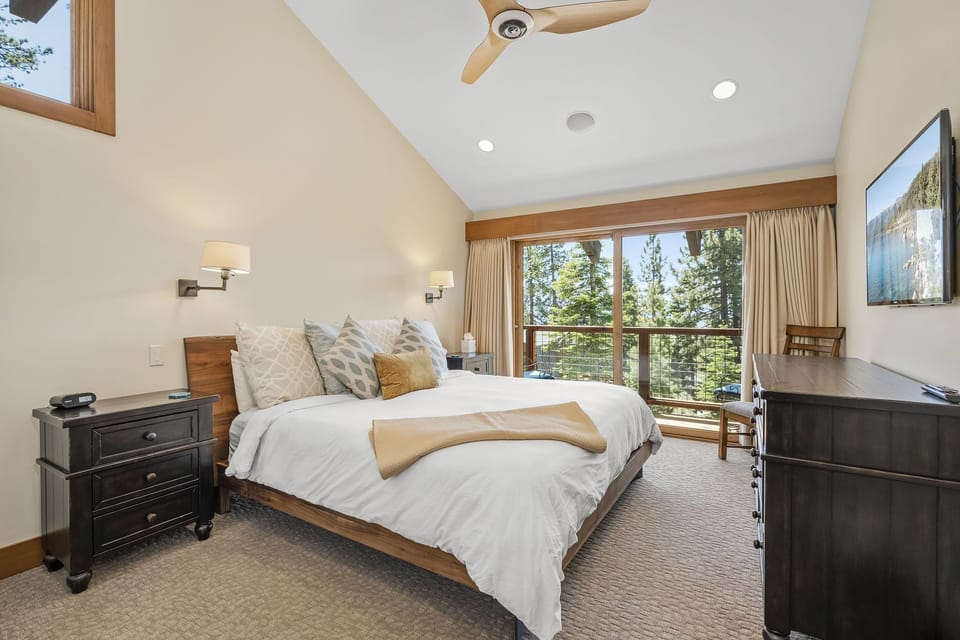 Primary Suite with TV, private balcony, and en suite bath
