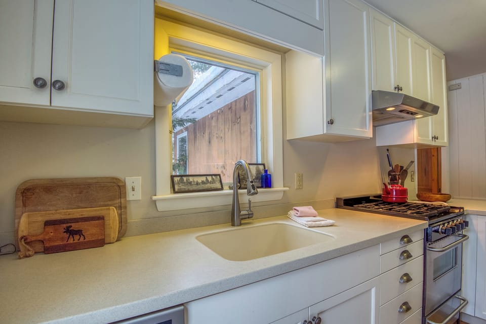 Well-stocked kitchen with cookware, dishes, and modern appliances.