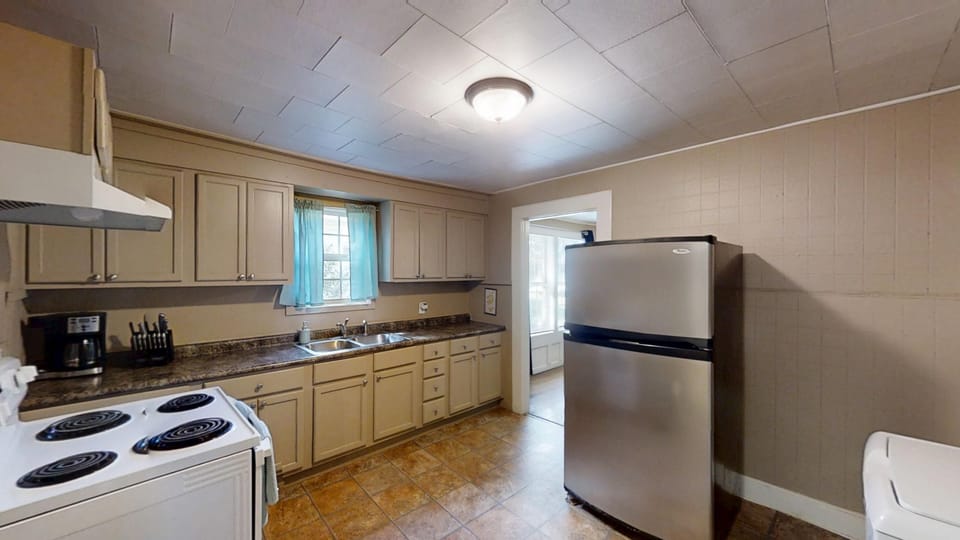 kitchen with all the cooking utencils, flatware, pots and pans, dishes and glassware.  full size stove/oven, fridge, microwave, coffee maker/keurig, toaster, blender