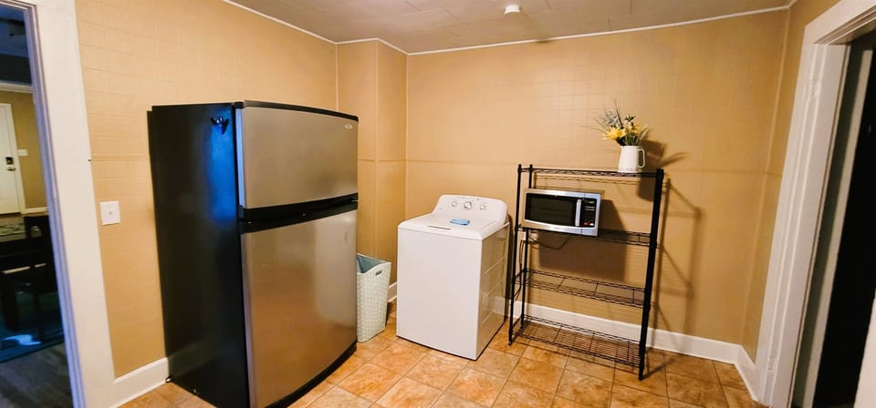 kitchen with full size washer and microwave