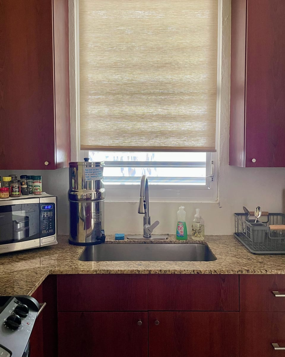 Sink window facing private back patio. Berkey water filter.
