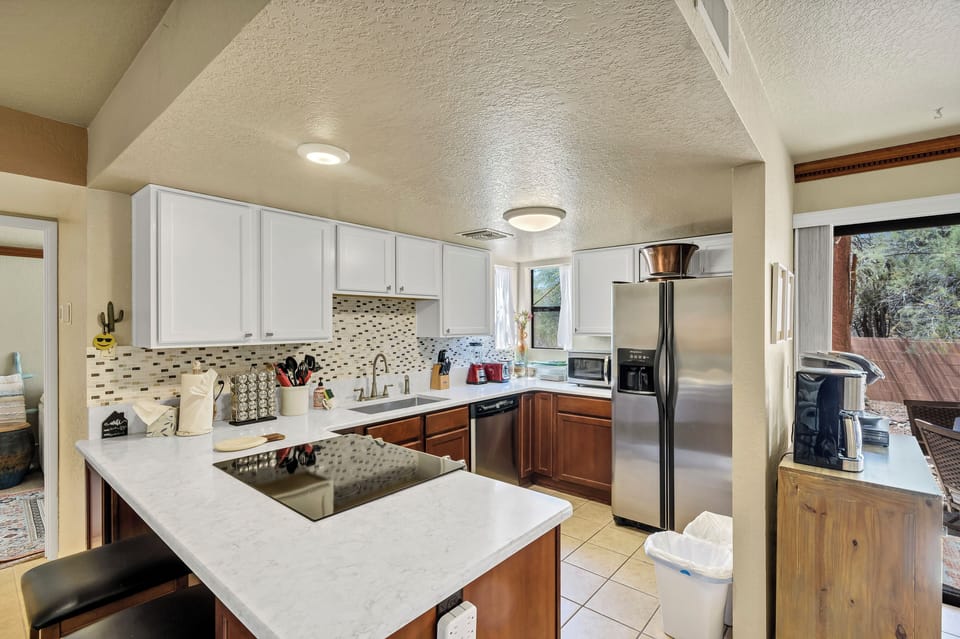Well stocked kitchen with corian counter, stainless appliances and marble accent