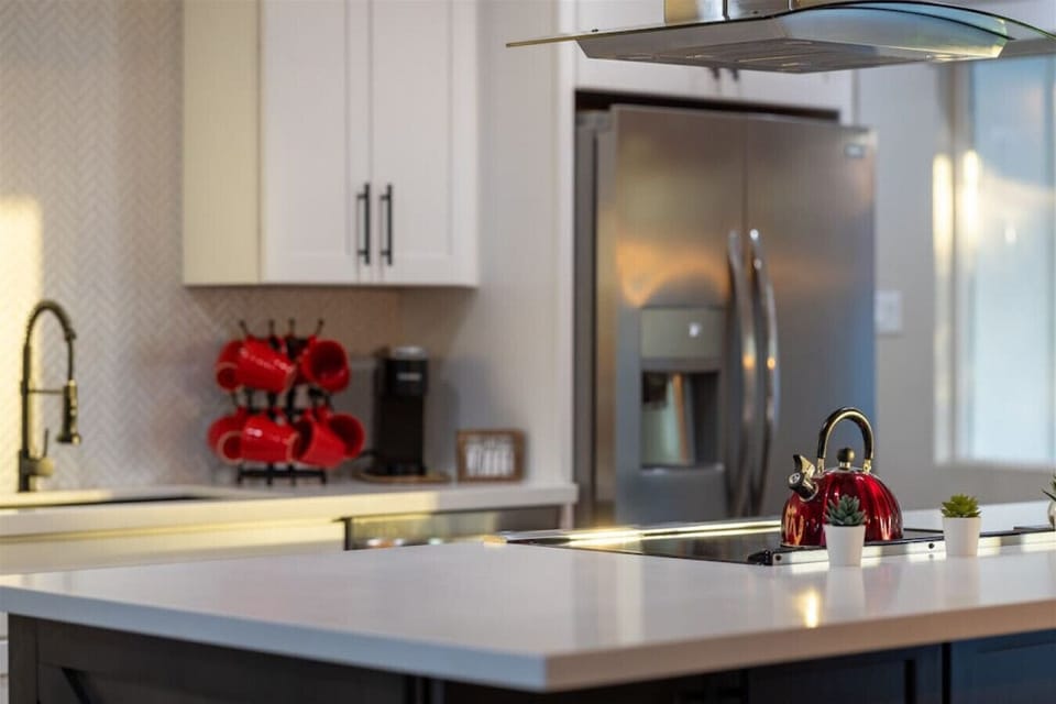 Get ready to cook in style! This kitchen features top-of-the-line stainless steel appliances and chic white cabinets.