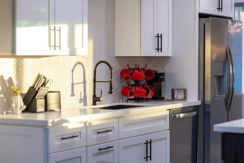 Get ready to cook in style! This kitchen features top-of-the-line stainless steel appliances and chic white cabinets.
