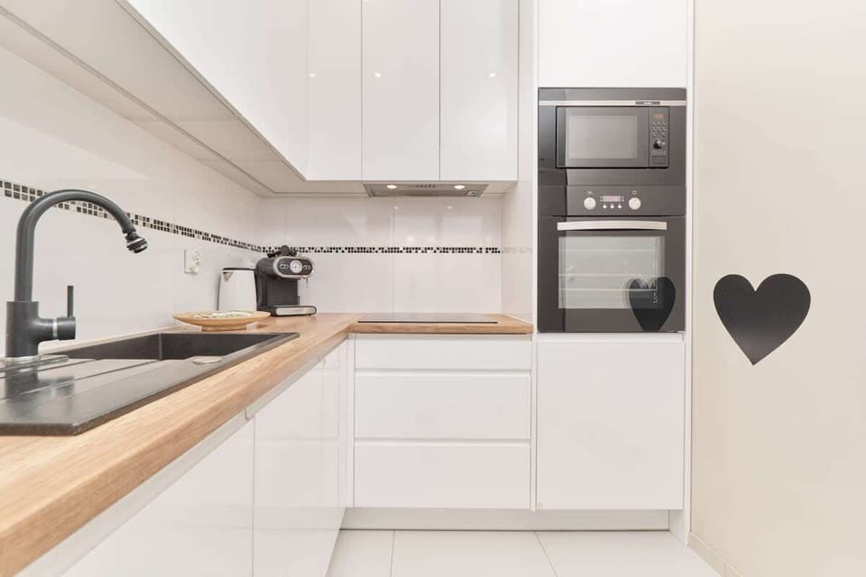 The sleek design of the kitchenette blending seamlessly with the living area.