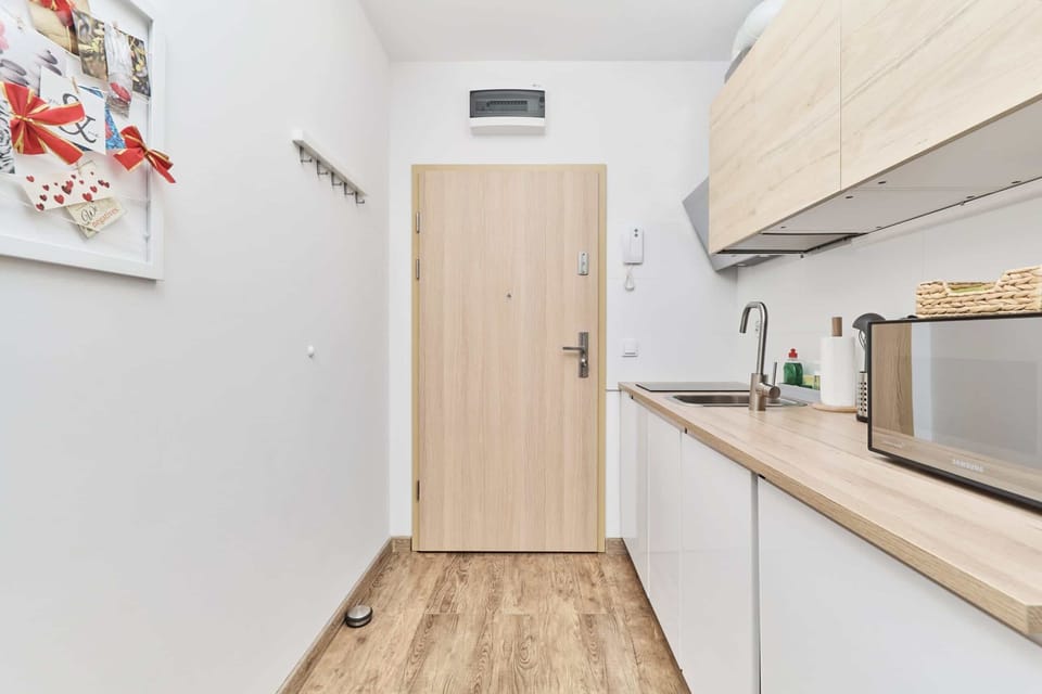 The sleek design of the kitchenette blending seamlessly with the living area.