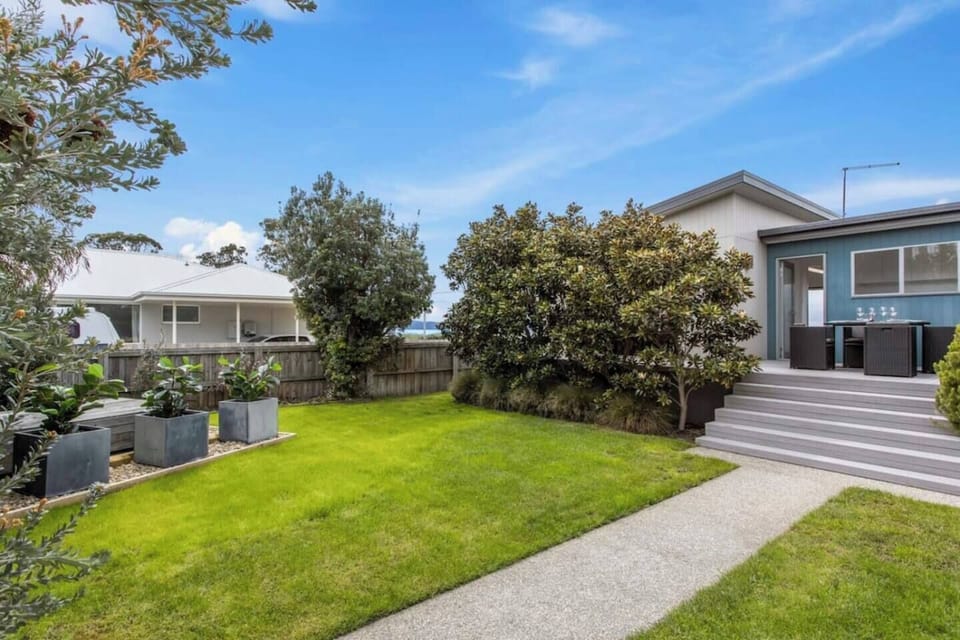 A grassy backyard offers ample space for the play with the kids, picnic or lay out in the sun.