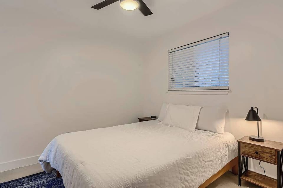 A simple and peaceful pool house bedroom with clean, modern design.