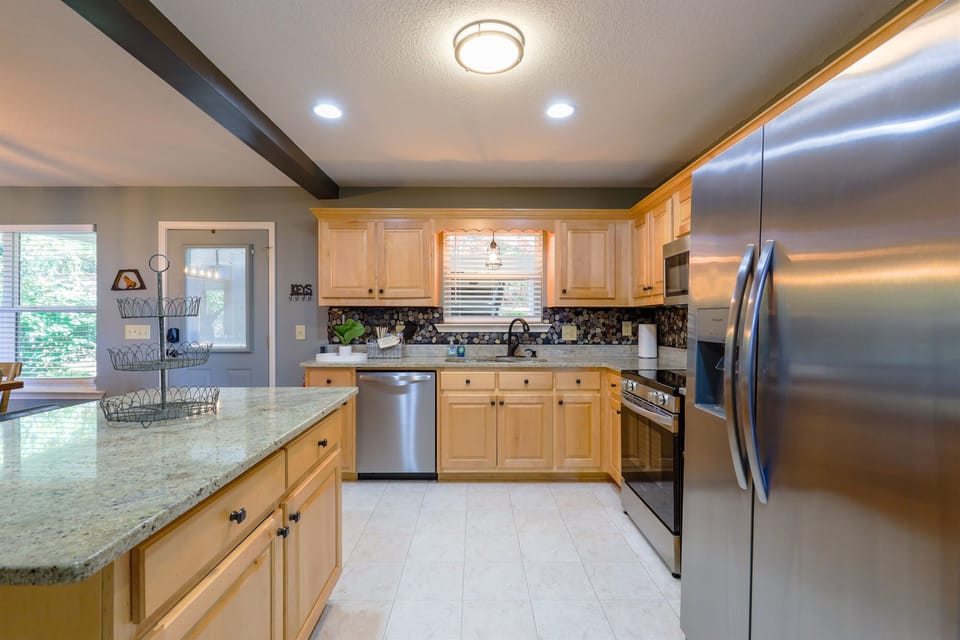 Cook up your favorite meals in this fully equipped kitchen, featuring modern appliances, spacious counters, and a warm design that invites you to gather, create, and enjoy together.
