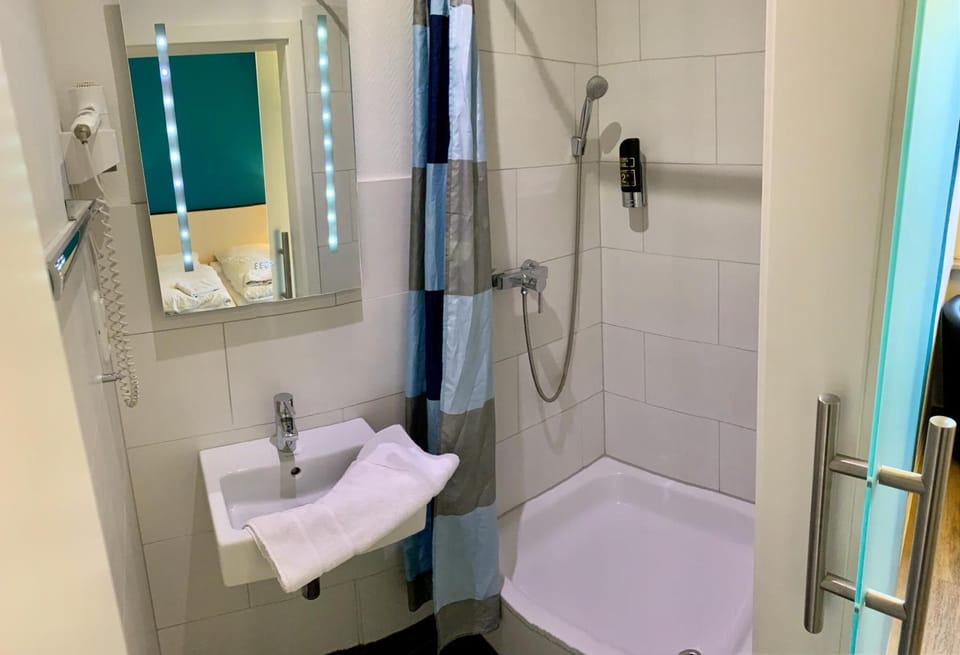 Shower, hair dryer, towels, toilet paper