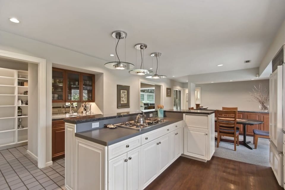 Your gourmet kitchen awaits with granite counters, premium appliances, and an inviting island perfect for cooking memorable meals together.