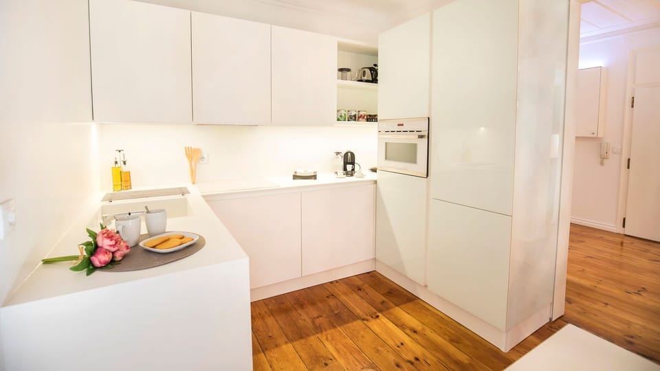 Clean lines, warm wooden floors, and a minimalist kitchen designed for effortless living. Bright, functional, and beautifully curated, this space blends modern comfort with understated elegance. #LovelyStay #ModernKitchen #MinimalDesign