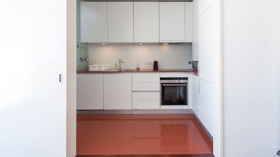 Unleash your inner chef in this sleek, fully-equipped kitchen, offering everything you need to prepare delicious meals with ease. The minimalist design ensures a clutter-free and enjoyable cooking experience.