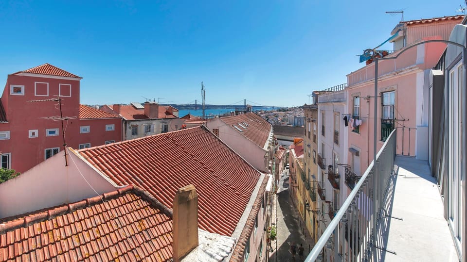 The apartment's southwest-facing balcony is narrow but long and offers incredible views of the River Tagus at sunset as well as the 25th April Bridge." #airbnb #airbnblisbon #portugal #pt #lisbon #view #river