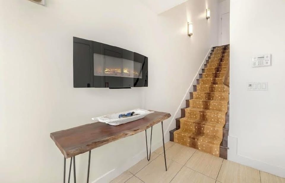 From here, we'll begin the walking tour of our home. When you enter through the front door, you'll be greeted by our cozy entry way and first set of stairs!