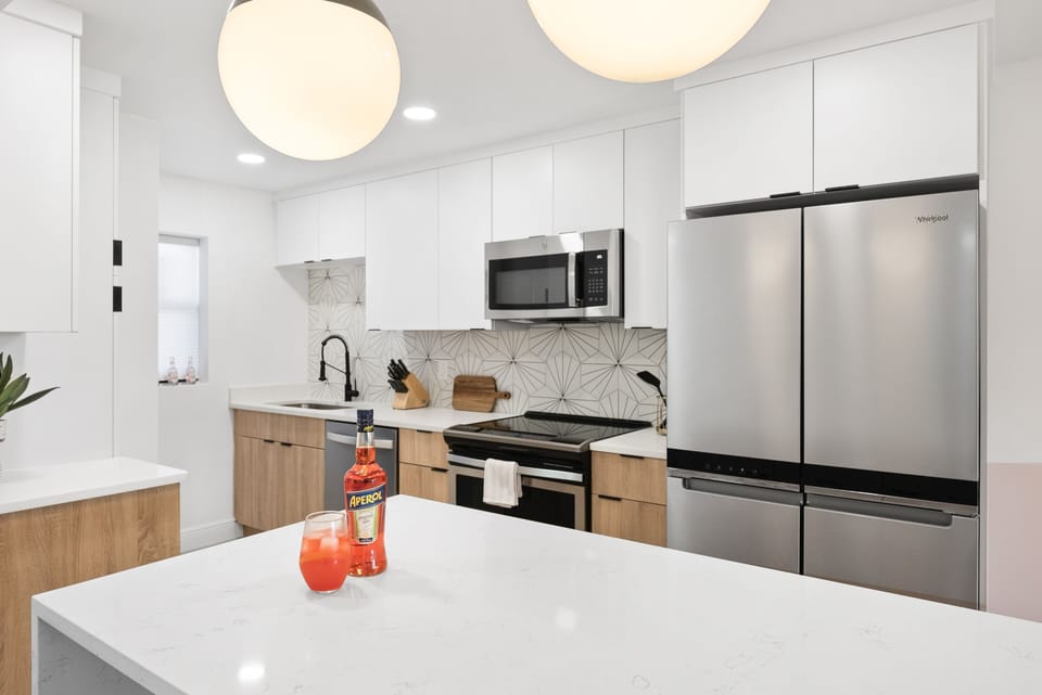 Modern kitchen with sleek finishes, stainless steel appliances, and elegant lighting.
