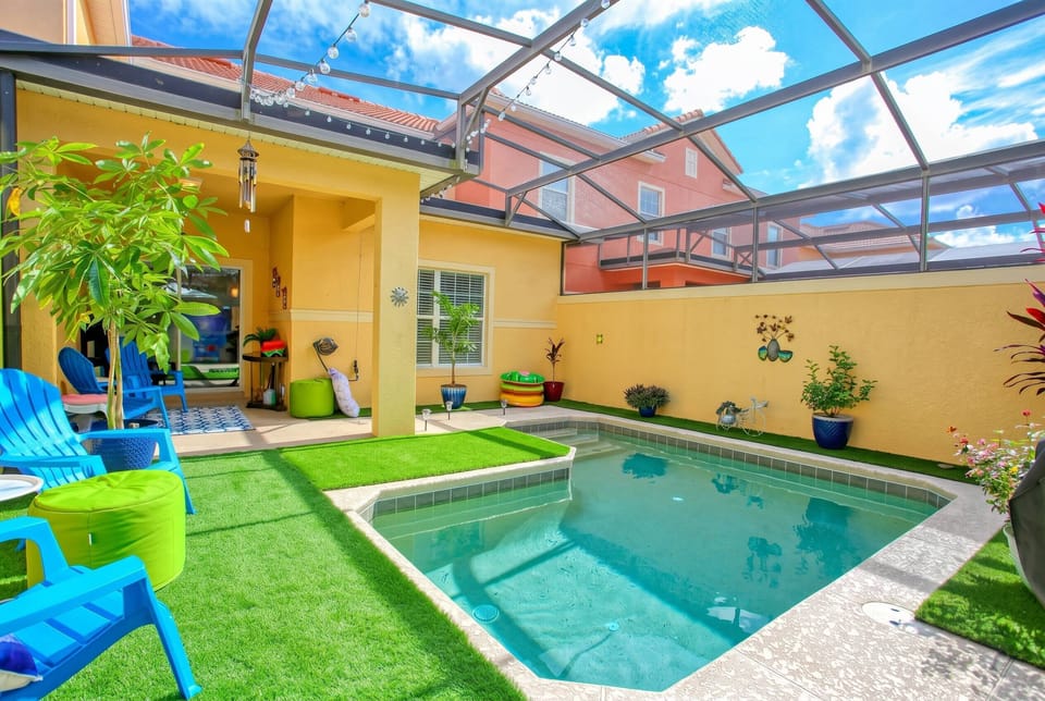 Enjoy your own private screened pool surrounded by colorful tropical décor, comfortable outdoor seating, and a relaxing atmosphere, perfect for cooling off and enjoying sunny Florida days.