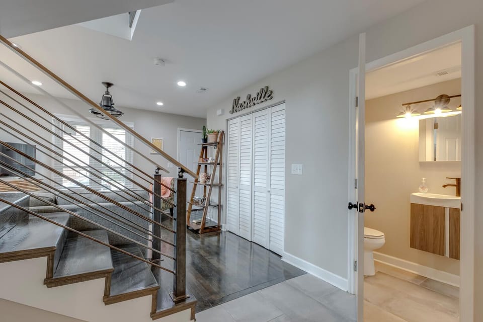 Bright entry with modern staircase and main-level half bath