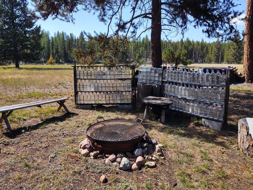 Fire pit with gin bottle wind shield