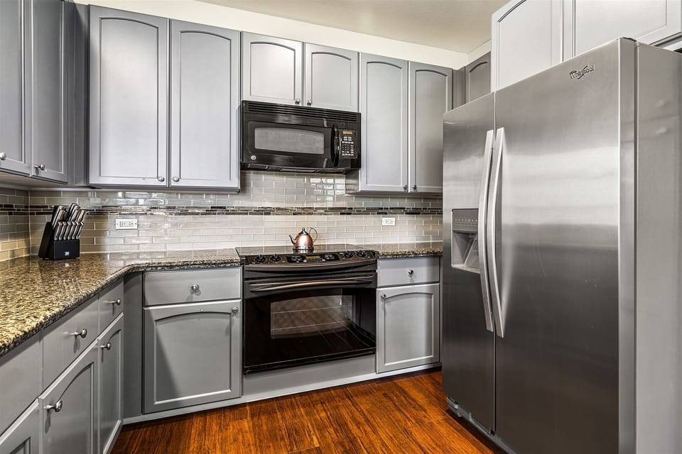 Full kitchen with granite counters and modern appliances