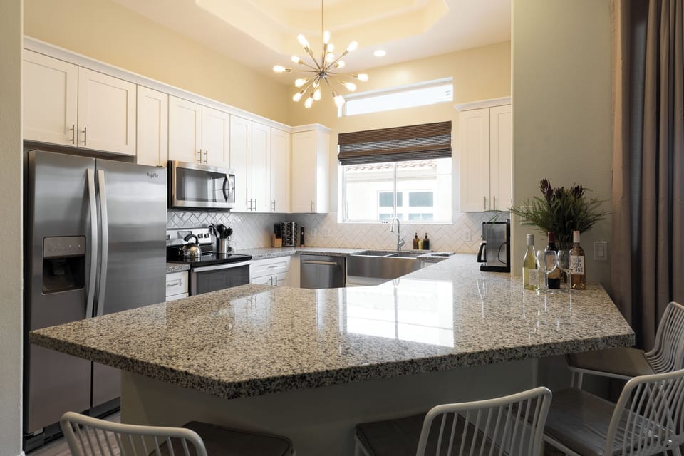 Modern kitchen with additional seating at the counter.