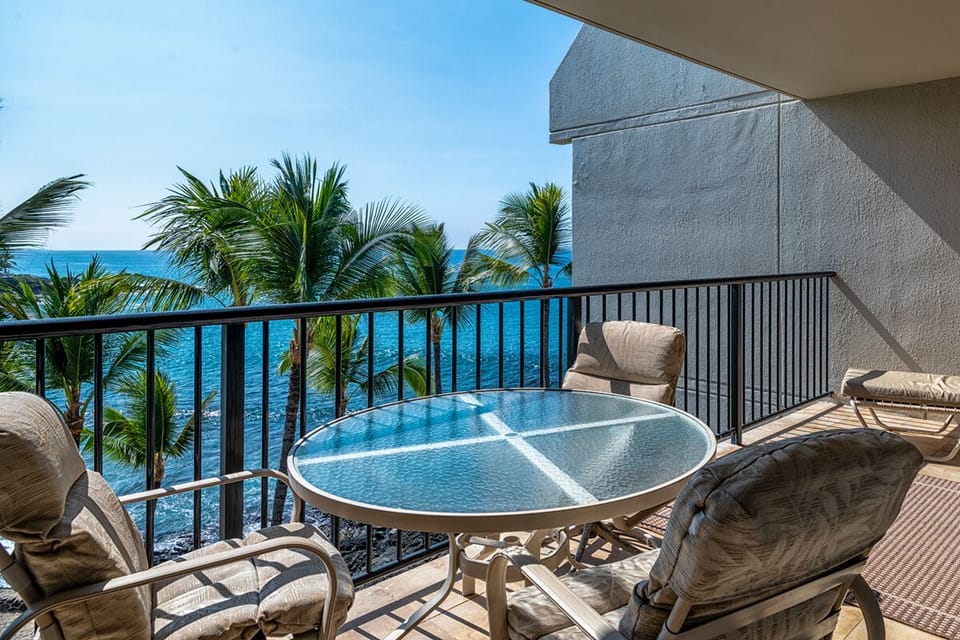 The lanai is so inviting with alluring Pacific views and sounds. Spacious lanai overlooking the ocean, natural saltwater pool, and private sandy beach — an unbeatable spot for sunsets.