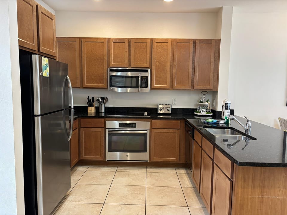 Kitchen area with granite counter tops and stainless steel appliances