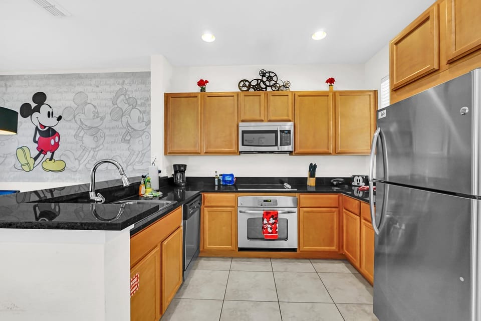 Fully equipped kitchen with stainless appliances and solid surface countertops