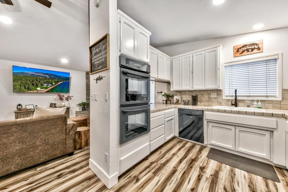 The kitchen is complete with double ovens, a dishwasher, built-in microwave, and French door fridge/freezer.