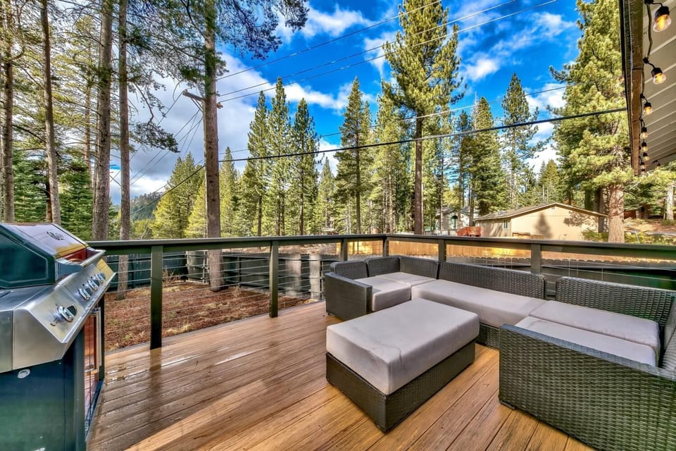 Unwind on your private deck with forest views, modern seating, and BBQ grill ready for mountain evenings.
